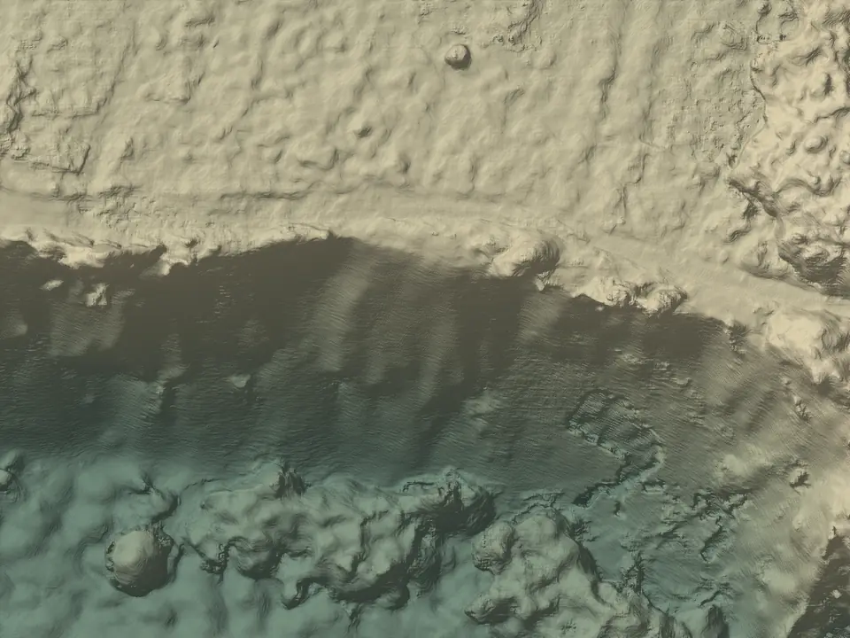 The surface model of the same ground, shaded and coloured by height: the face a band of shadow, trees as bumps below it.