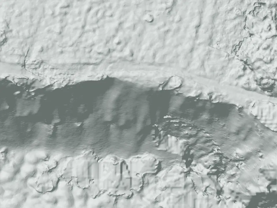 The terrain model of the same ground, shaded grey, with contour lines bunched along the quarry face and square filled-in patches under the trees below it.