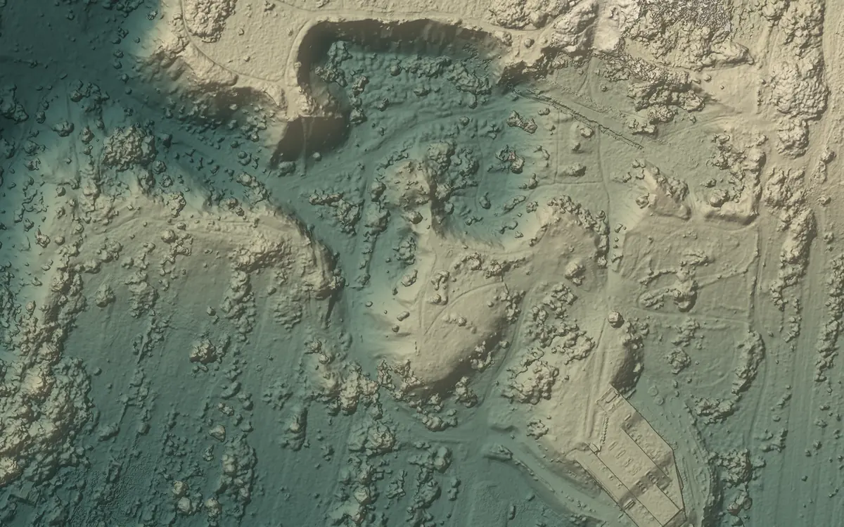 The same ground as shaded relief, coloured from dark teal for the lowest ground to pale sand for the highest.